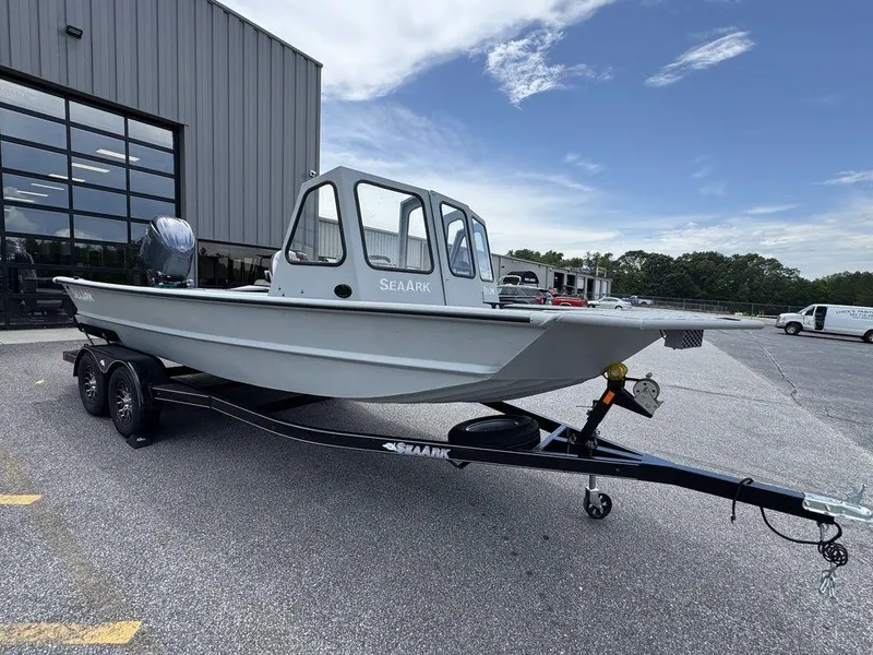 Slide: The Image of 2026 SeaArk 2072 MV Flat Cat boat on trailer, parked outside a building. - 3