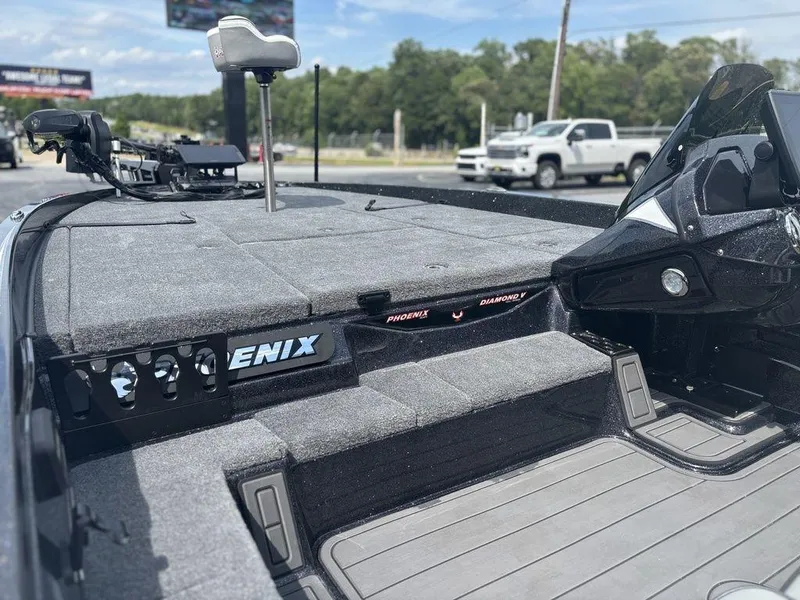 Slide: The Image of 2026 Phoenix 921 Elite X II boat interior with carpeted deck and seating. - 11