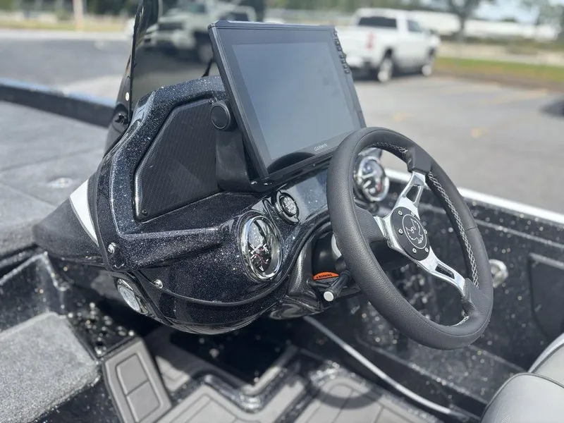 Slide: The Image of 2026 Phoenix 921 Elite X II boat dashboard with steering wheel and digital display. - 15