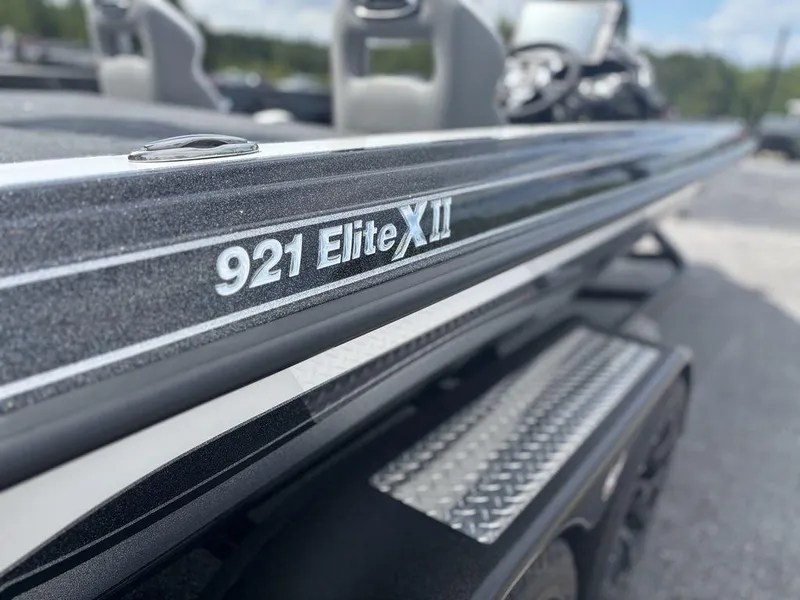 Slide: The Image of 2026 Phoenix 921 Elite X II boat, close-up of model name on sleek exterior. - 18