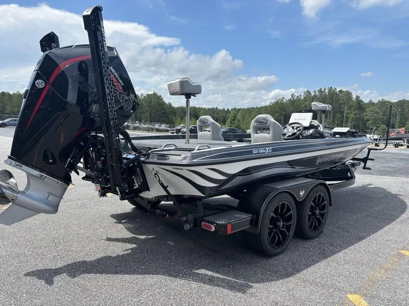 Slide: The Image of 2026 Phoenix 921 Elite X II boat with powerful outboard motor, parked on a trailer. - 2