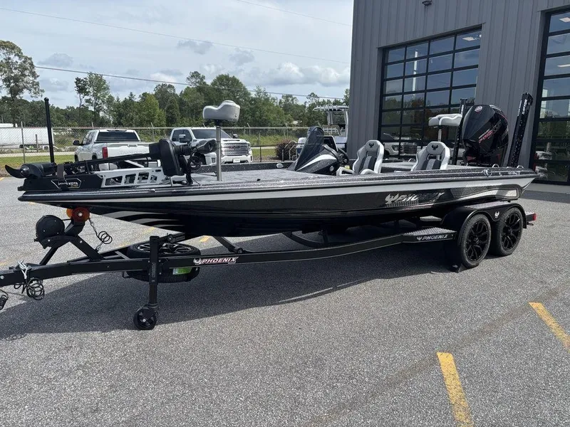 Slide: The Image of 2026 Phoenix 921 Elite X II boat on trailer, parked outside a building. - 25