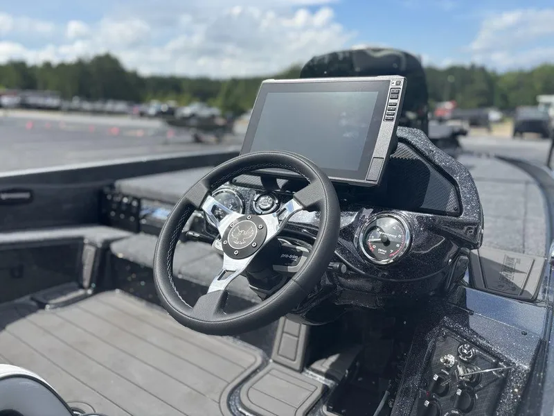 Slide: The Image of 2026 Phoenix 921 Elite X II boat dashboard with steering wheel and digital display. - 5