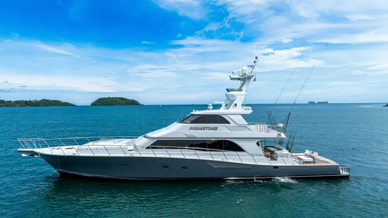 Slide: The Image of 2002 Queenship 98 Yachtfish cruising on open sea under clear blue sky. - 1