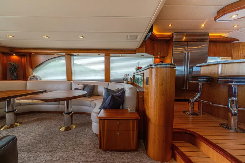 Slide: The Image of Luxurious interior of 2002 Queenship 98 Yachtfish with elegant seating and modern kitchen area. - 10