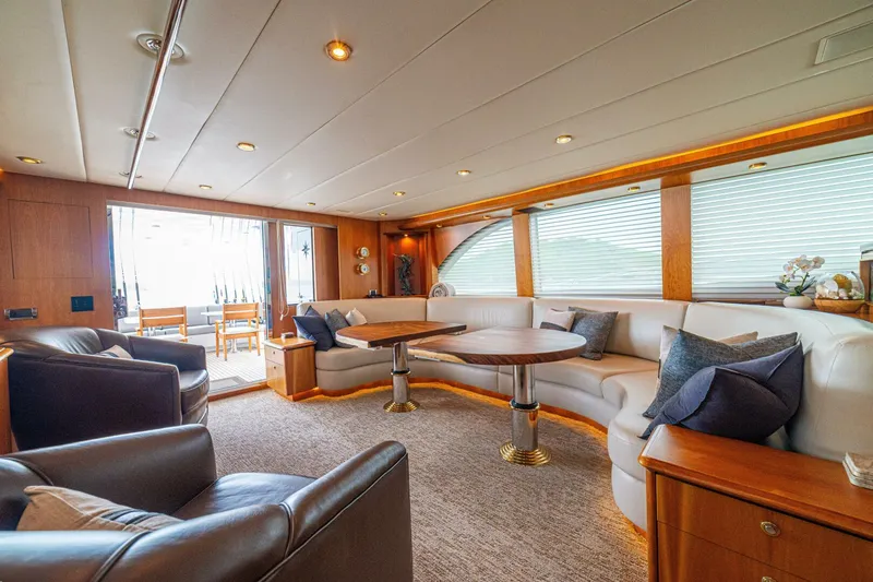 Slide: The Image of Luxurious interior of 2002 Queenship 98 Yachtfish with elegant seating and wooden accents. - 11