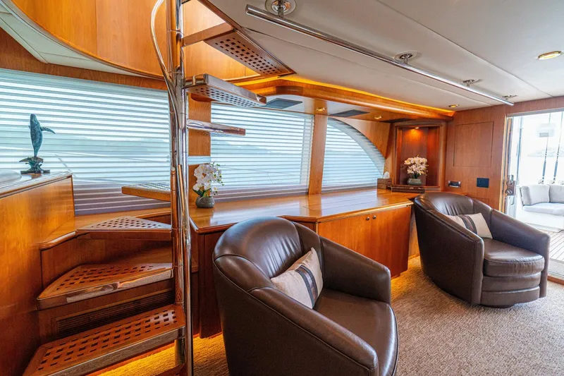Slide: The Image of Luxurious interior of 2002 Queenship 98 Yachtfish with elegant wood finishes and plush seating. - 12