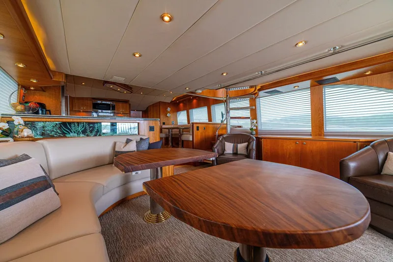 Slide: The Image of Luxurious interior of 2002 Queenship 98 Yachtfish with elegant wood finishes and plush seating. - 16