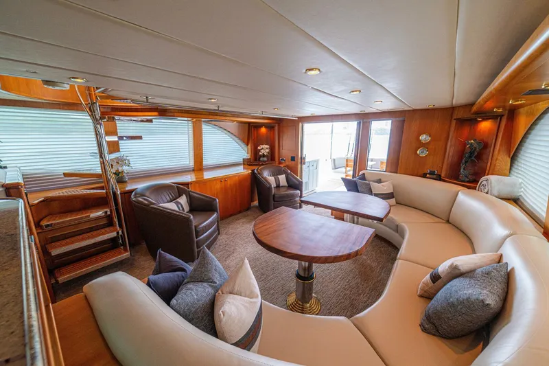 Slide: The Image of Luxurious 2002 Queenship 98 Yachtfish interior with elegant seating and wooden accents. - 18