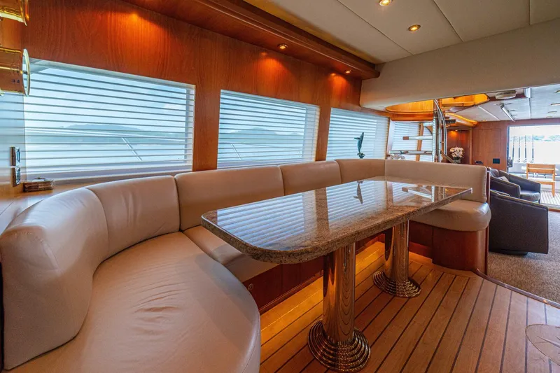 Slide: The Image of Luxurious interior of 2002 Queenship 98 Yachtfish with elegant dining area and plush seating. - 19