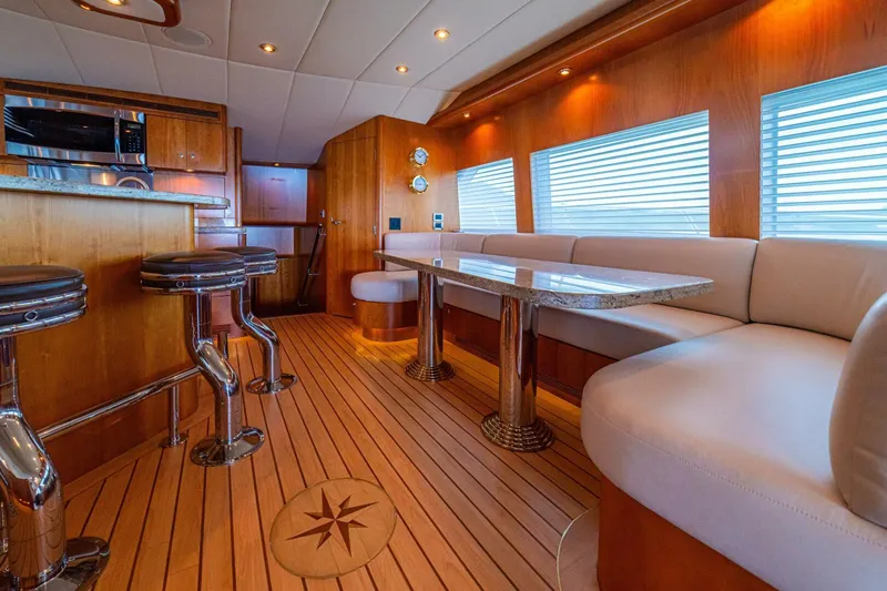 Slide: The Image of Luxurious 2002 Queenship 98 Yachtfish interior with elegant wood finishes and modern seating. - 20