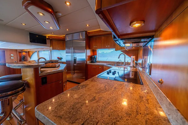 Slide: The Image of Luxurious kitchen interior of 2002 Queenship 98 Yachtfish with modern appliances and elegant wood finish. - 21
