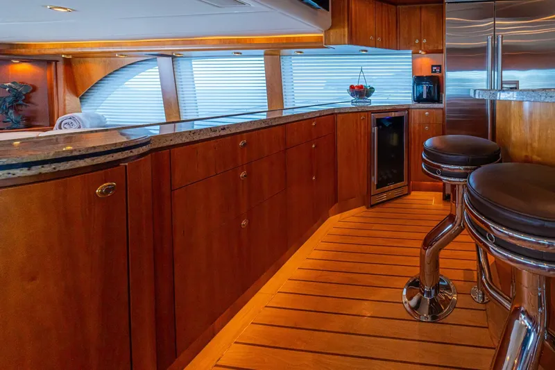 Slide: The Image of Luxurious kitchen interior of 2002 Queenship 98 Yachtfish with wooden cabinetry and modern appliances. - 23