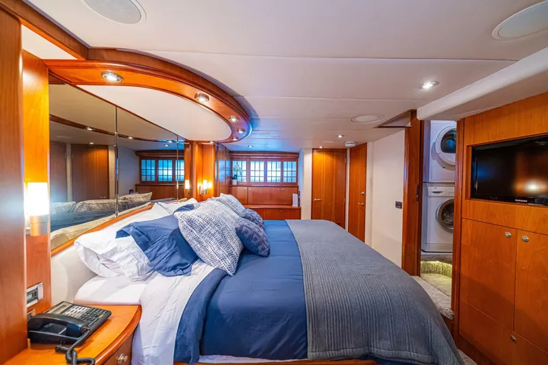 Slide: The Image of Luxurious bedroom interior of 2002 Queenship 98 Yachtfish, featuring elegant wood finishes and modern amenities. - 31