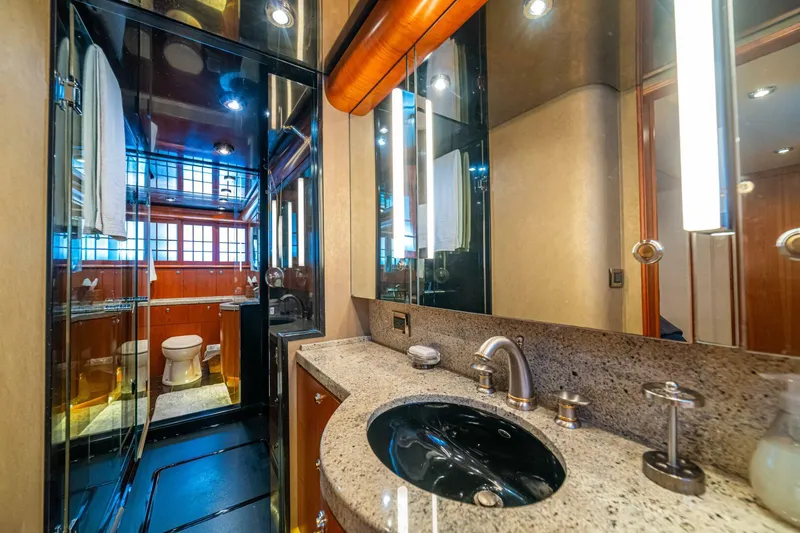 Slide: The Image of Luxurious bathroom on 2002 Queenship 98 Yachtfish, featuring elegant fixtures and modern design. - 36