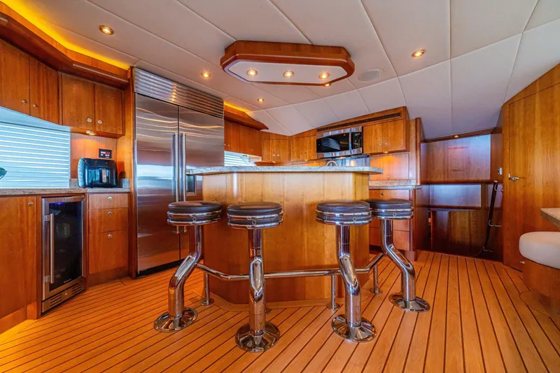 Slide: The Image of Luxurious 2002 Queenship 98 Yachtfish kitchen with wood cabinetry and modern appliances. - 9