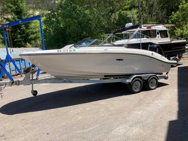 Slide: The Image of 2021 Sea Ray SPX 210 Outboard boat on trailer, parked outdoors. - 2