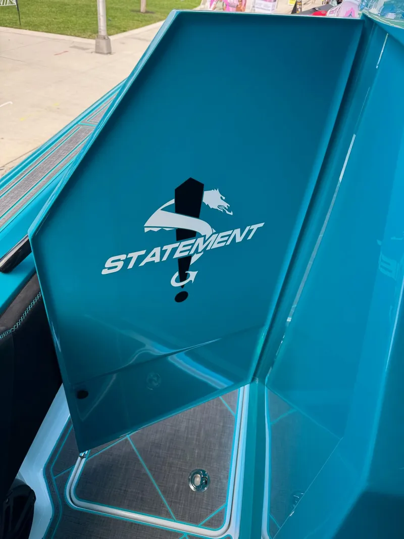 Slide: The Image of 2026 Statement 430 Tigress Center Console Catamaran interior with logo on blue panel. - 14