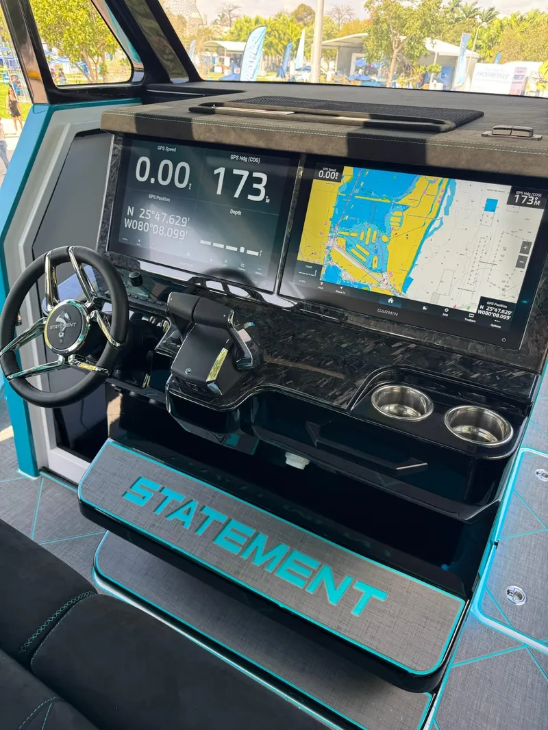 Slide: The Image of 2026 Statement 430 Tigress Catamaran dashboard with navigation screens and steering wheel. - 15