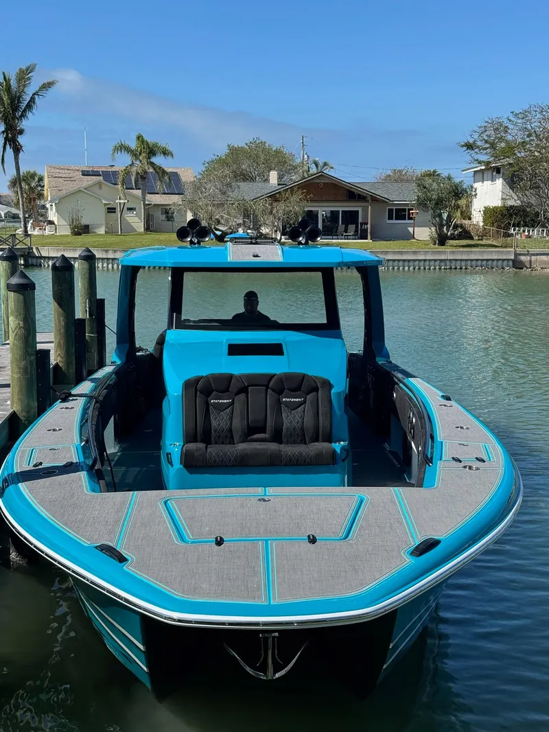 Slide: The Image of 2026 Statement 430 Tigress Center Console Catamaran docked in a serene waterfront setting. - 19