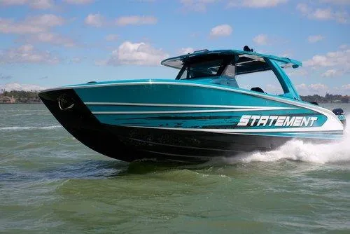 Slide: The Image of 2026 Statement 430 Tigress Center Console Catamaran cruising on open water. - 21