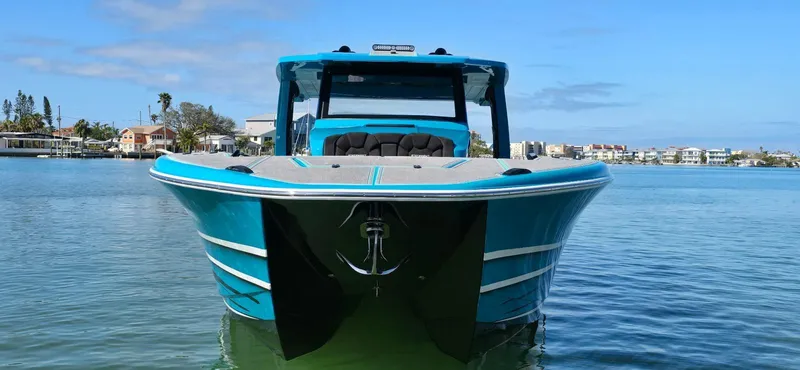 Slide: The Image of 2026 Statement 430 Tigress Center Console Catamaran on calm water, showcasing sleek design. - 3