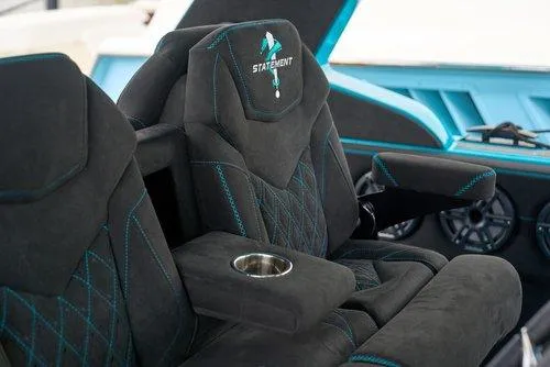 Slide: The Image of 2026 Statement 430 Tigress Catamaran interior with plush seating and cup holder. - 6