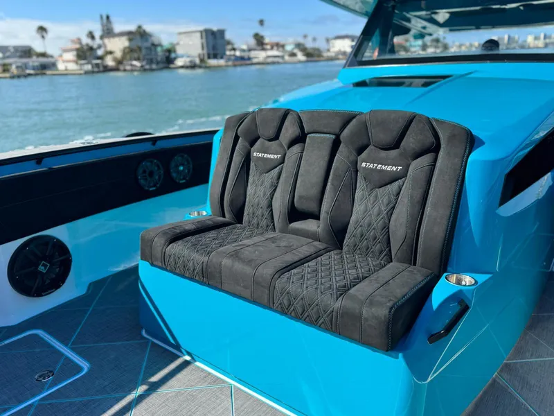 Slide: The Image of Luxury seating on 2026 Statement 430 Tigress Center Console Catamaran, with waterfront view. - 8