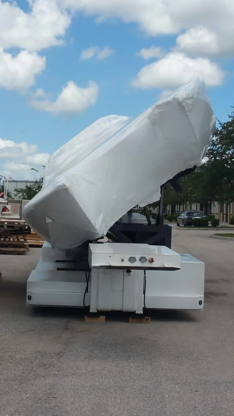 Slide: The Image of 2012 Mystic Powerboats 50 Cat covered in protective wrap, parked outdoors under a cloudy sky. - 5