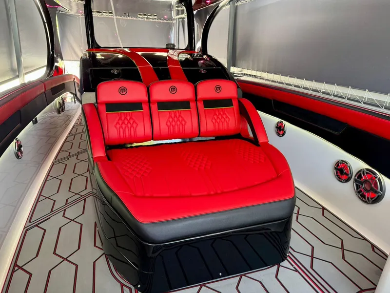Slide: The Image of Luxurious interior of 2018 Mystic Powerboats M4200 with red and black seating. - 12