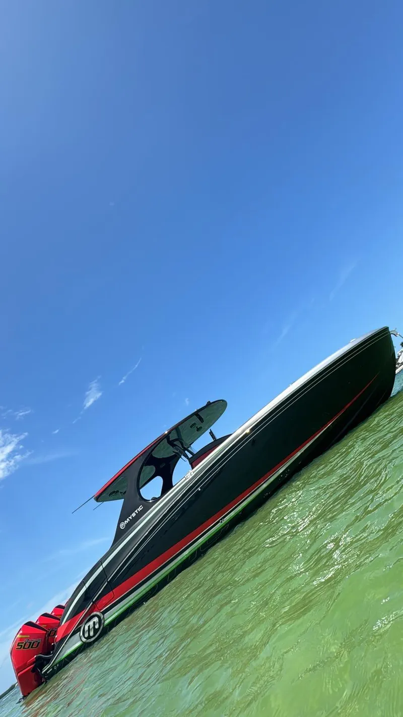 Slide: The Image of 2018 Mystic Powerboats M4200 on clear water under a bright blue sky. - 26