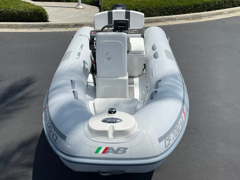 Slide: The Image of 2013 AB Inflatables Lammina 10 AL inflatable boat, parked on pavement, viewed from the front. - 17
