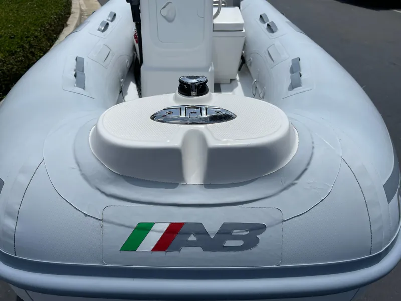 Slide: The Image of 2013 AB Inflatables Lammina 10 AL boat, white with logo, docked on pavement. - 8
