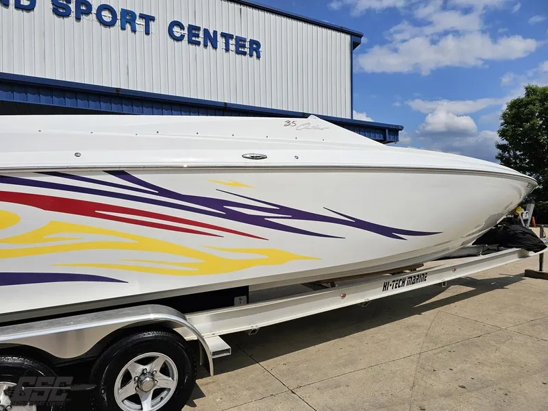 Slide: The Image of 2007 Baja 35 Outlaw boat with colorful graphics on trailer at sport center. - 10
