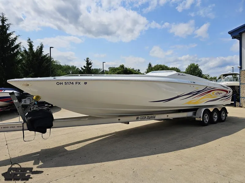 Slide: The Image of 2007 Baja 35 Outlaw speedboat on trailer, vibrant graphics, parked outdoors under blue sky. - 17