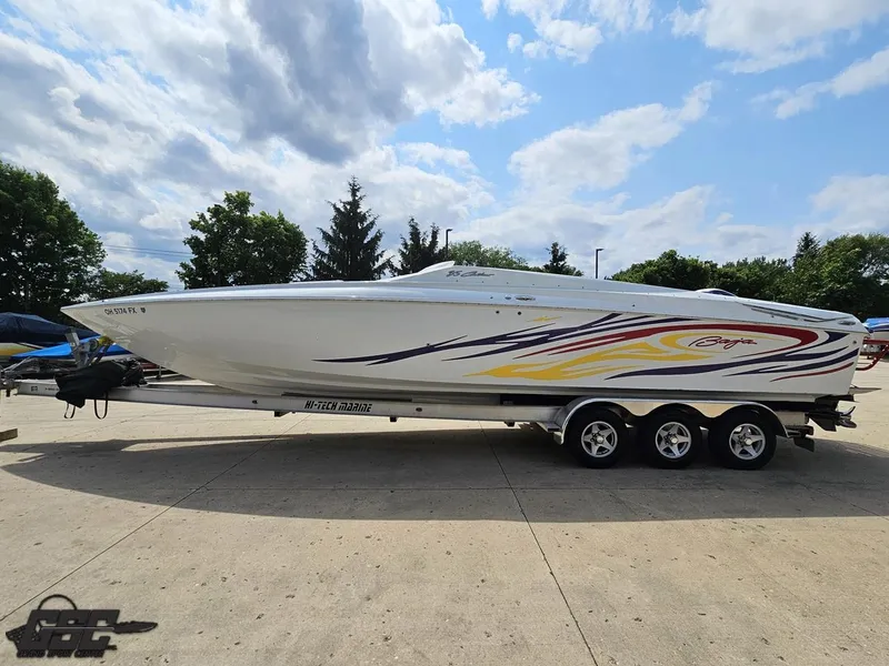Slide: The Image of 2007 Baja 35 Outlaw speedboat on trailer under a partly cloudy sky. - 18