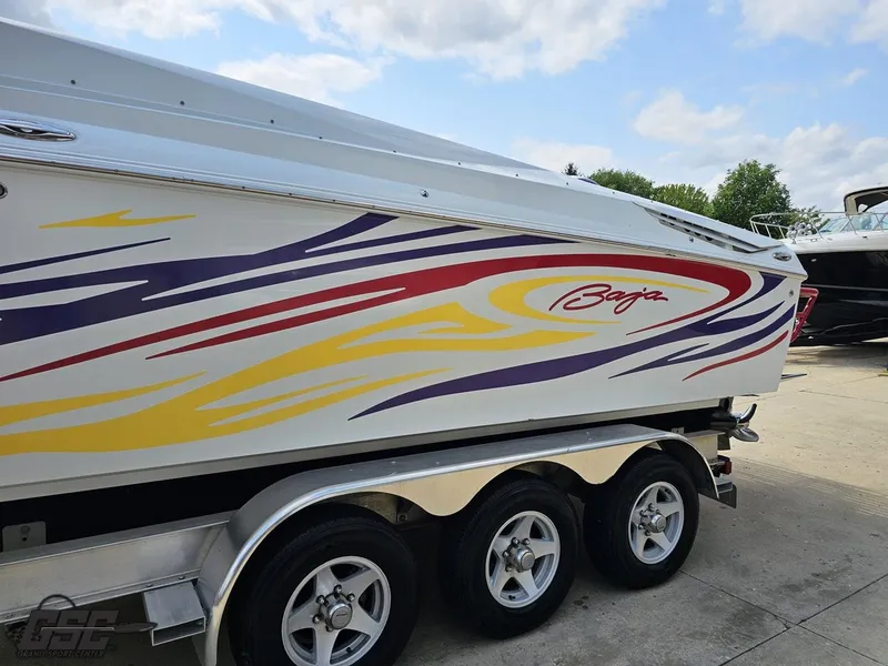 Slide: The Image of 2007 Baja 35 Outlaw boat with colorful graphics on a trailer. - 21