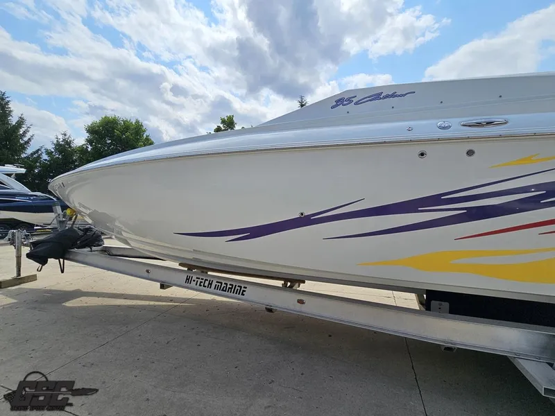 Slide: The Image of 2007 Baja 35 Outlaw boat on trailer with colorful graphics under a cloudy sky. - 24