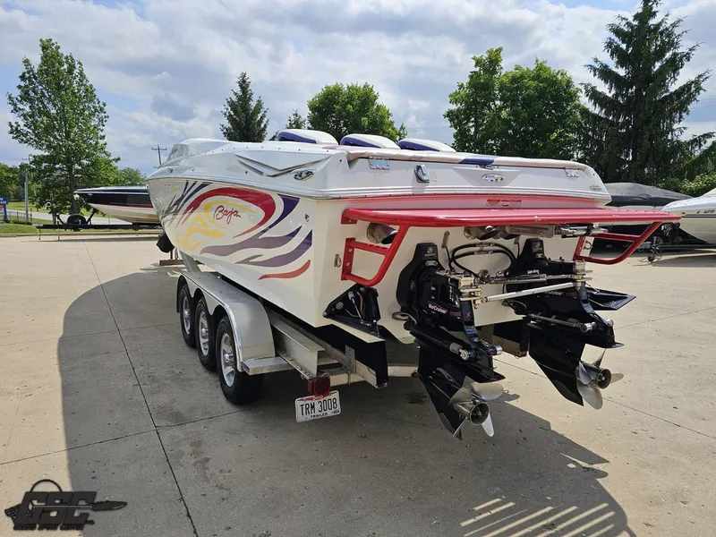 Slide: The Image of 2007 Baja 35 Outlaw boat with vibrant graphics, parked on a trailer. - 28
