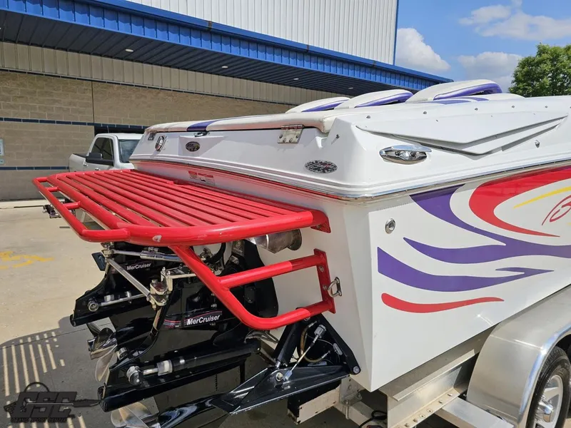 Slide: The Image of 2007 Baja 35 Outlaw boat with vibrant graphics and red swim platform. - 31