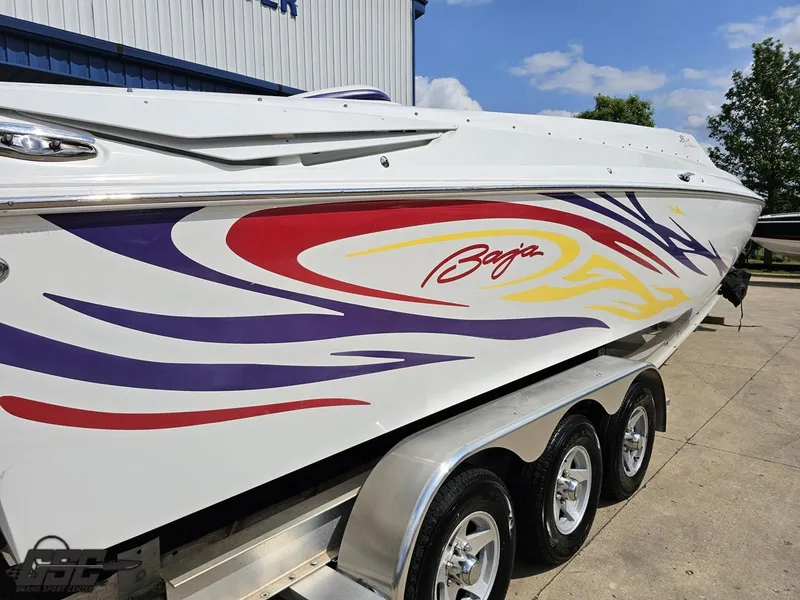 Slide: The Image of 2007 Baja 35 Outlaw boat with colorful graphics on a trailer. - 32