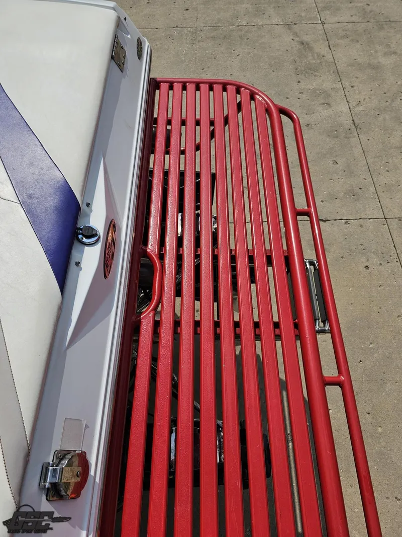 Slide: The Image of 2007 Baja 35 Outlaw boat with red metal railing and white seating. - 33