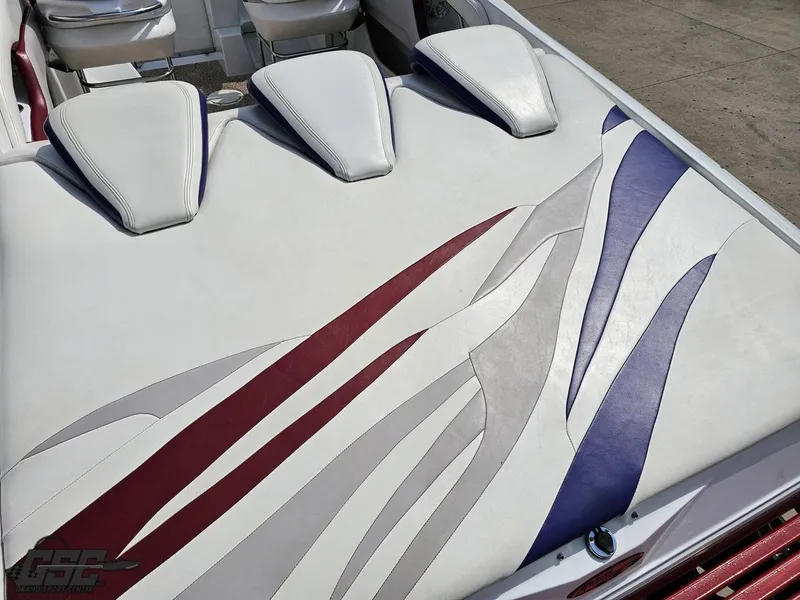 Slide: The Image of 2007 Baja 35 Outlaw boat interior with stylish white, red, and blue upholstery design. - 35