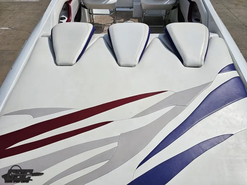 Slide: The Image of 2007 Baja 35 Outlaw boat interior with white, red, and blue upholstery design. - 37