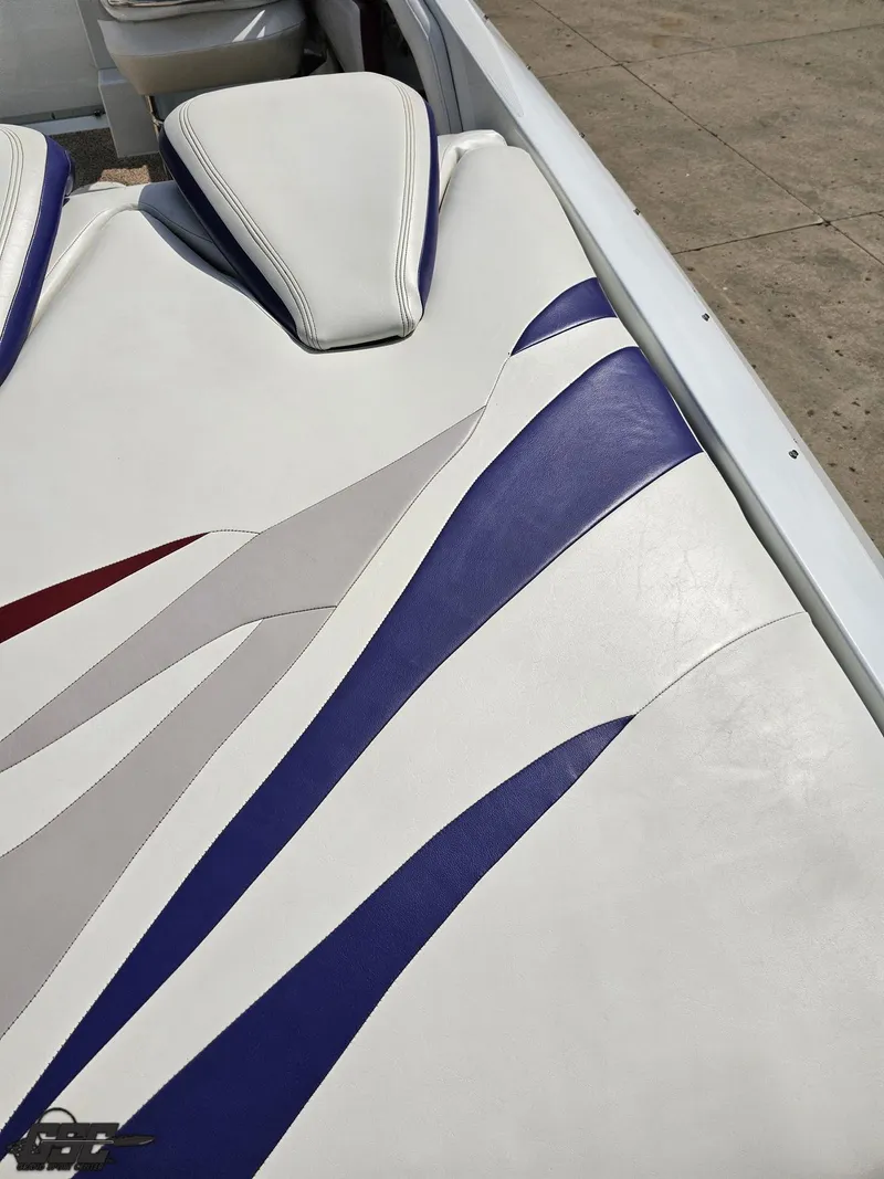 Slide: The Image of 2007 Baja 35 Outlaw boat interior with white, blue, and gray upholstery design. - 40
