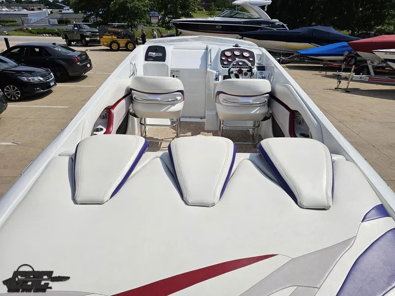 Slide: The Image of 2007 Baja 35 Outlaw boat interior with white seating and dashboard, parked outdoors. - 41