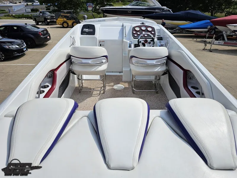 Slide: The Image of 2007 Baja 35 Outlaw boat interior with white seating and dashboard controls. - 42