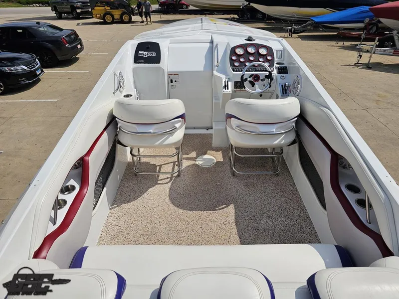 Slide: The Image of 2007 Baja 35 Outlaw boat interior with white seating and dashboard controls. - 43
