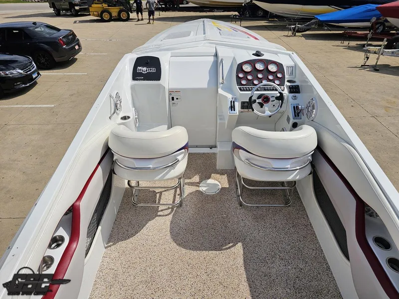 Slide: The Image of 2007 Baja 35 Outlaw boat interior with white seating and dashboard controls. - 44
