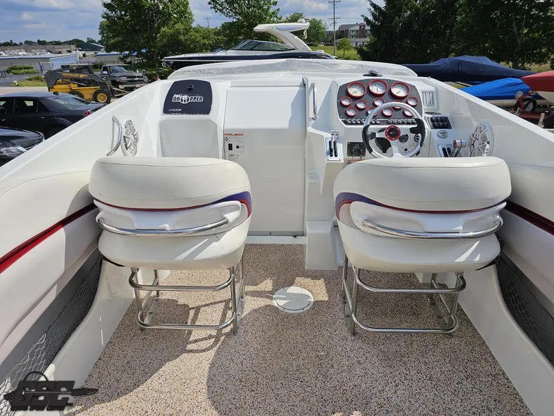 Slide: The Image of 2007 Baja 35 Outlaw boat cockpit with white seats and control panel. - 46